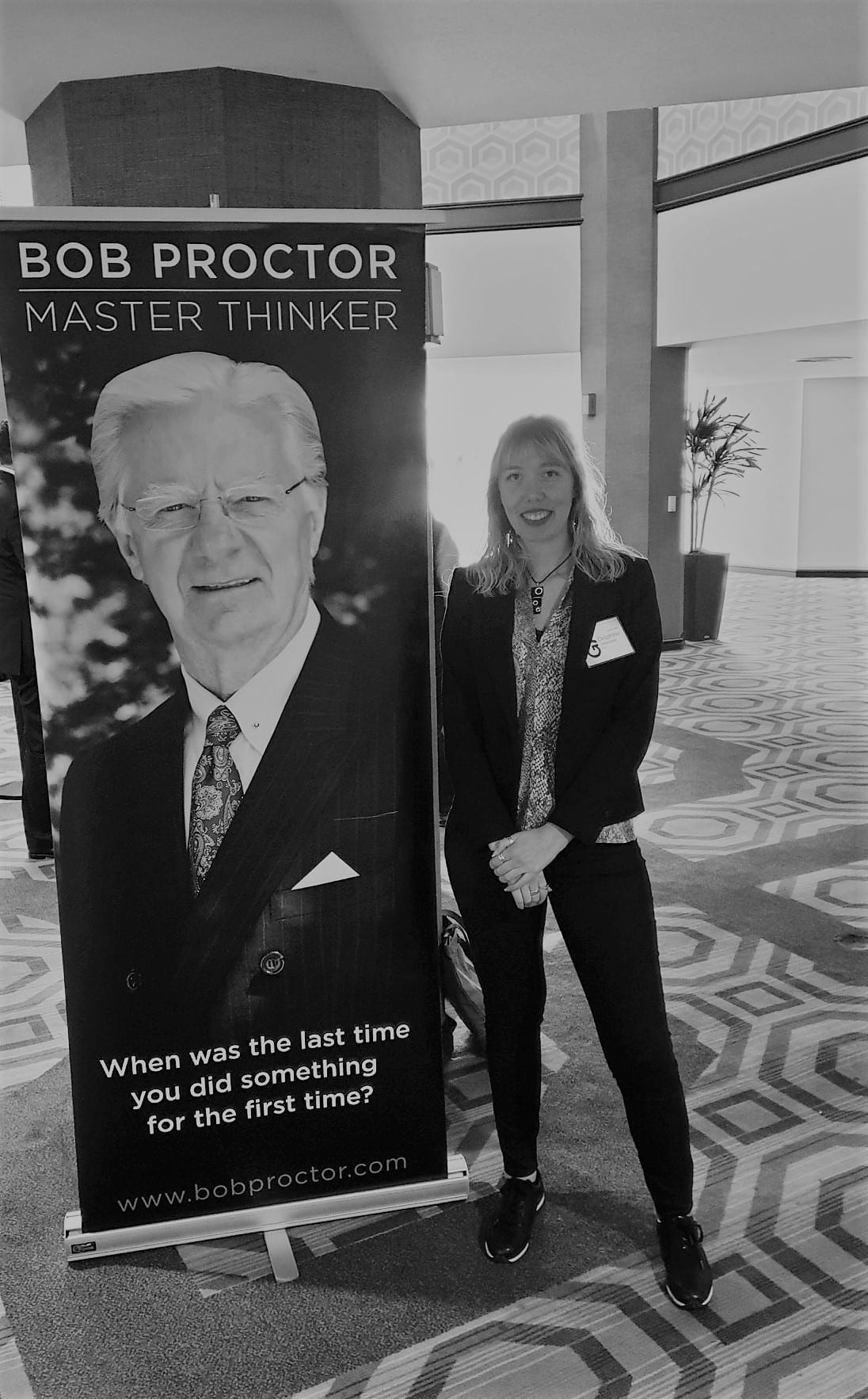 Delphine in Los Angeles, next to the poster of Bob Proctor’s seminar